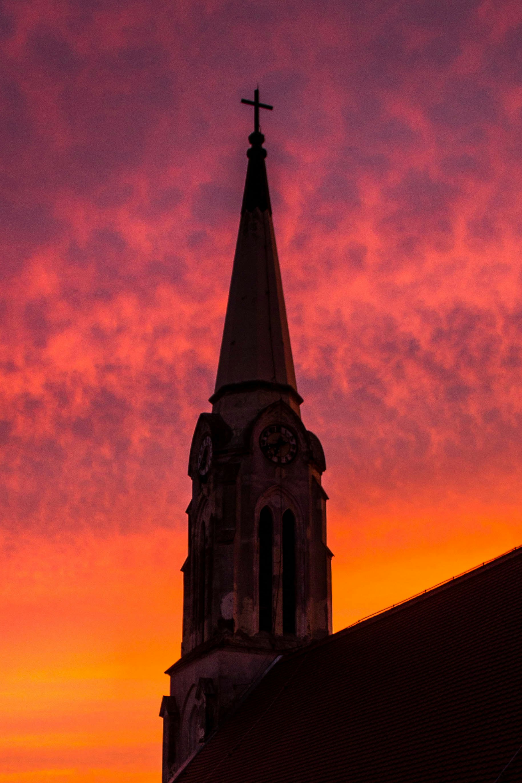 brown and black concrete building under orange and purple sky